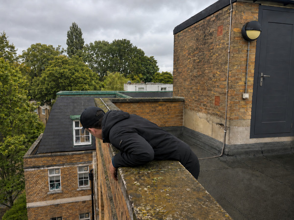 Roofer inspecting gutters and fascias
